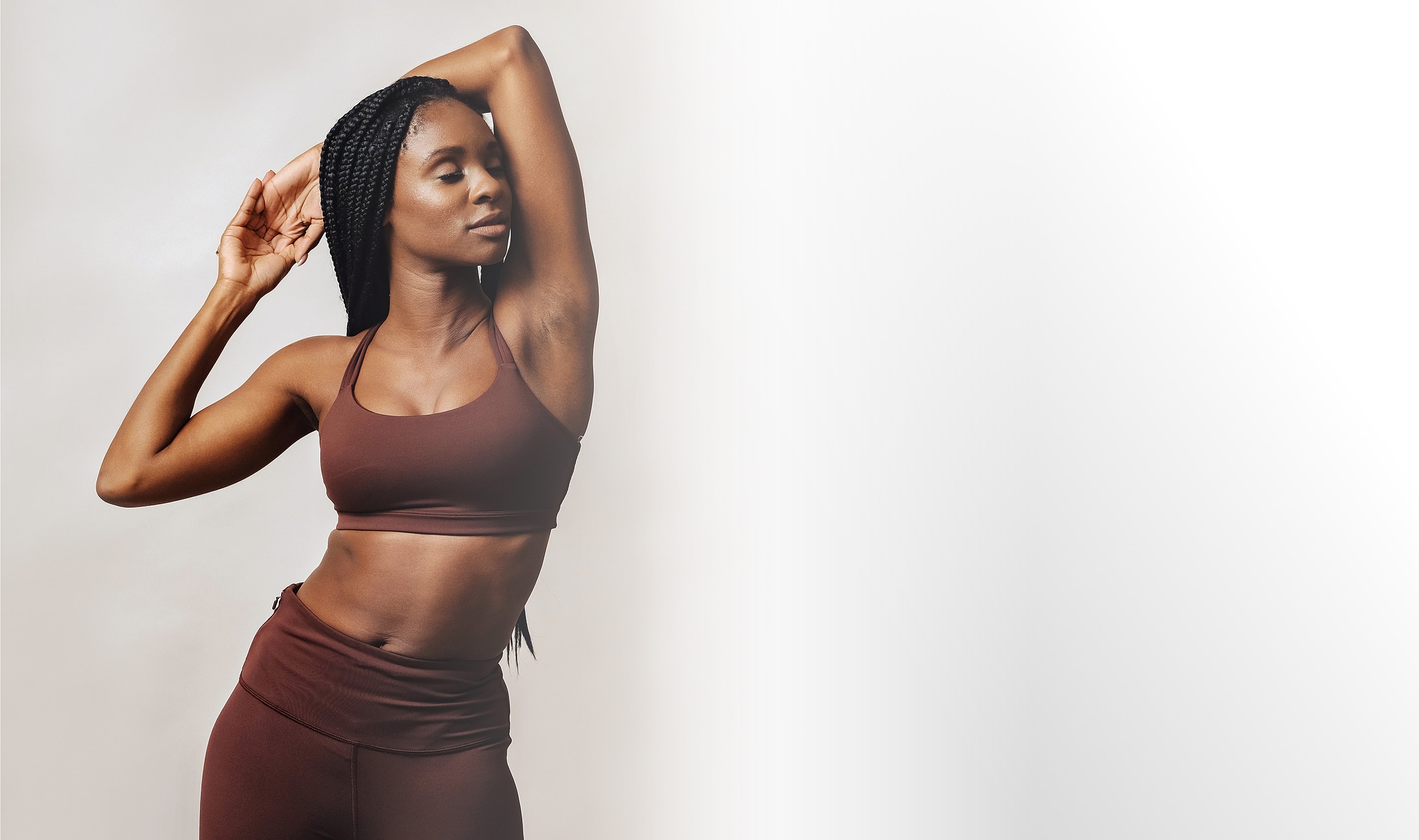 Gainesville, FL liposuction model in athletic wear posing confidently.