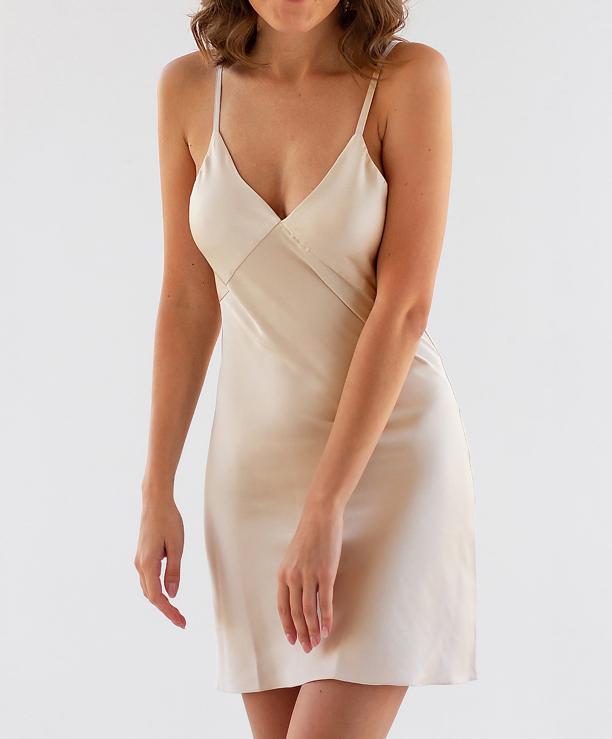 Gainesville, FL mommy makeover model wearing a silky beige slip dress.