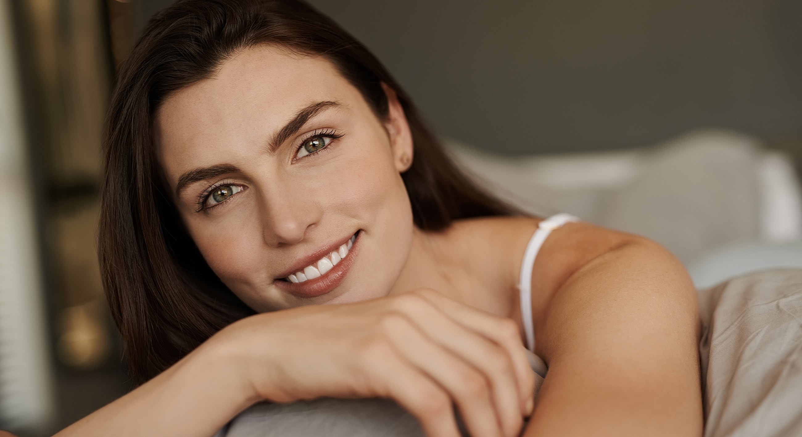 Gainesville, FL Enzyme Peel model lying on bed, natural lighting.